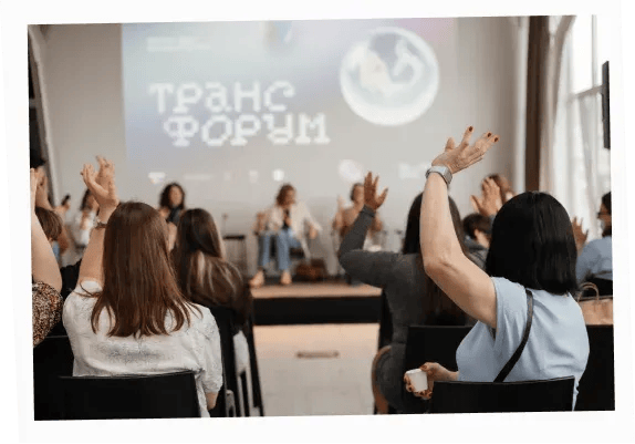 Audience members using the “silent applause” gesture during a session