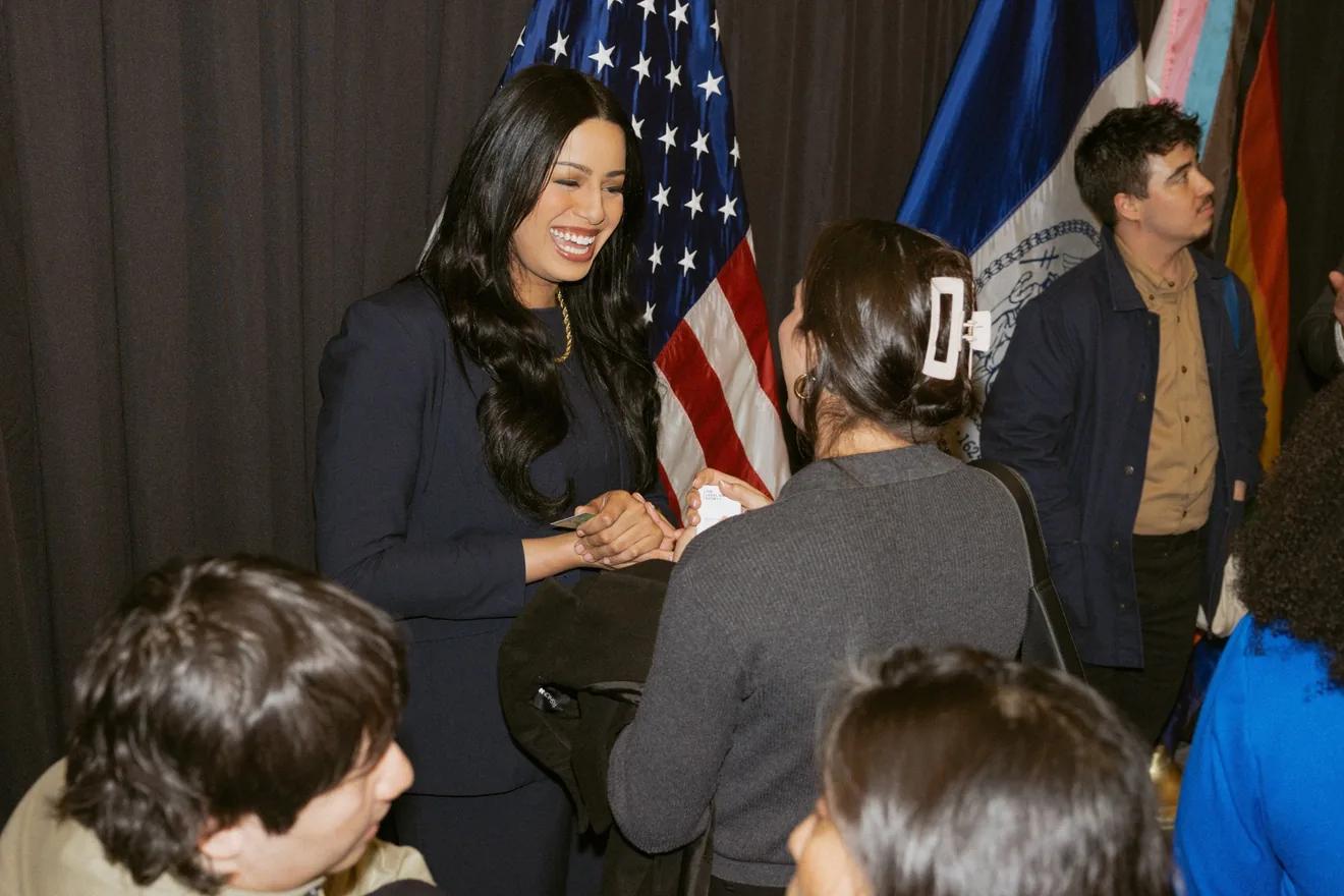 Taylor Brown smiles at the woman she is talking to at an official event