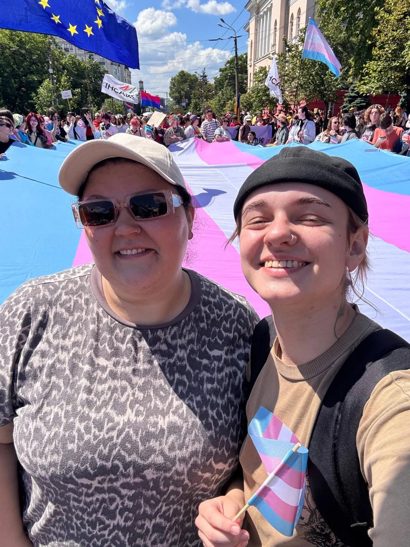 Kamila Safarova, director of the NGO Resistance, and Salvador Strizh, communications specialist, against the backdrop of the trans pride parade